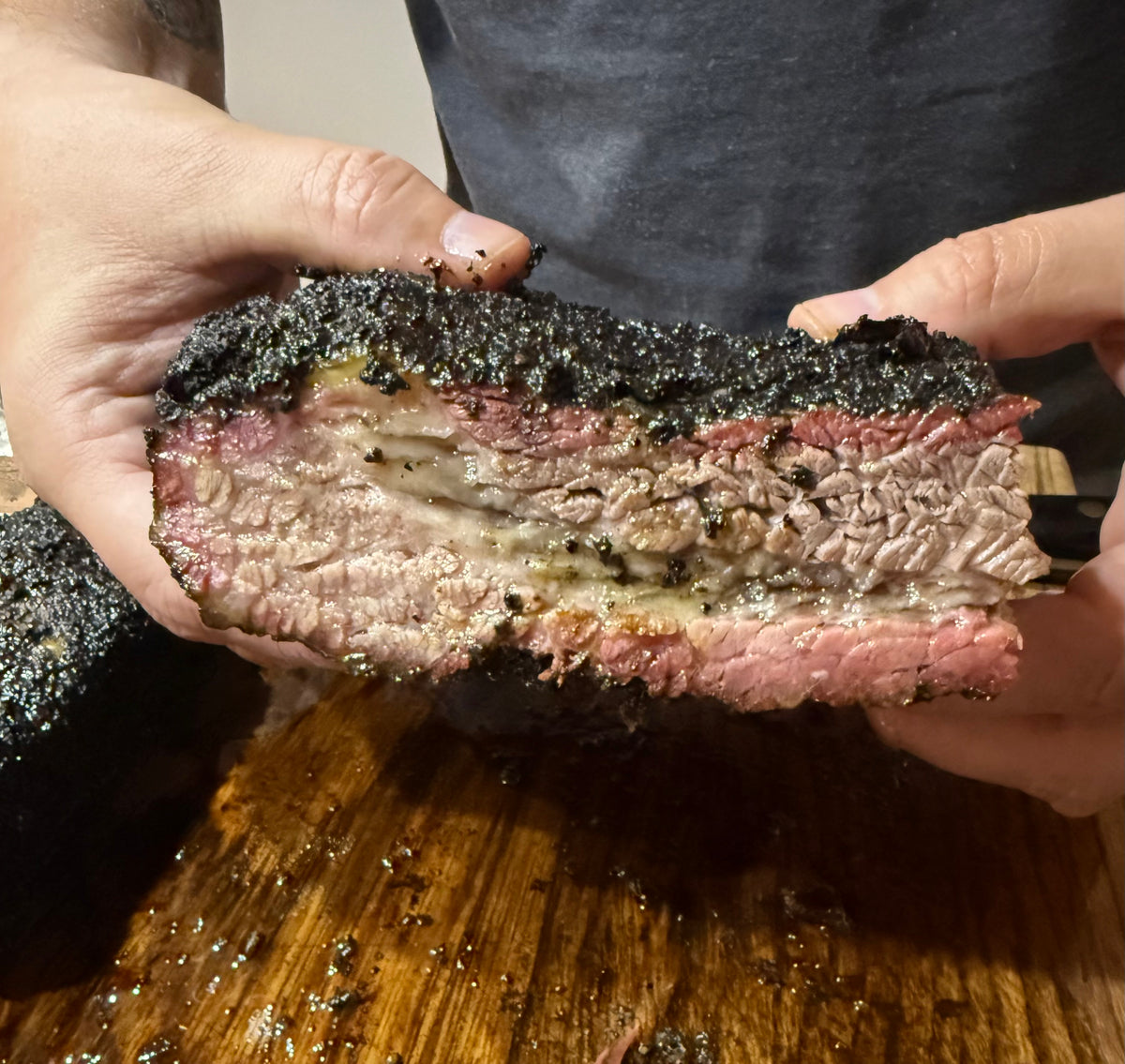 Sliced smoked brisket with smoke ring seasoned with Forge Black